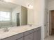 Bathroom featuring a double sink vanity with gray cabinets and a large mirror at 3354 Brunot St, New Hill, NC 27562