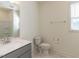 Bathroom featuring gray vanity with quartz countertop, single sink, toilet and a mirror reflecting the shower at 3354 Brunot St, New Hill, NC 27562