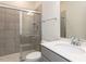 Well-lit bathroom featuring a glass-enclosed shower, sleek vanity and modern fixtures at 3354 Brunot St, New Hill, NC 27562