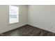 Cozy bedroom featuring new hardwood floors, a window, and crisp white walls at 3354 Brunot St, New Hill, NC 27562