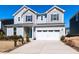 Charming two-story home with a blue front door and a spacious two-car garage and concrete driveway at 3354 Brunot St, New Hill, NC 27562