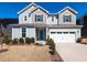 Charming two-story home with a blue front door and well manicured landscaping at 3354 Brunot St, New Hill, NC 27562