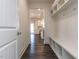 Hallway featuring a built-in storage and bench, leading into the kitchen area at 3354 Brunot St, New Hill, NC 27562