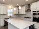 Gourmet kitchen with quartz countertops, stainless steel appliances, and stylish backsplash at 3354 Brunot St, New Hill, NC 27562