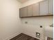 Well-lit laundry room featuring ample cabinet space and a convenient utility sink at 3354 Brunot St, New Hill, NC 27562