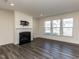 Inviting living room featuring fireplace, hardwood floors, neutral walls and ample natural light at 3354 Brunot St, New Hill, NC 27562