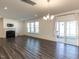 Open-concept living area with a fireplace and large windows for ample natural light and sliding glass doors at 3354 Brunot St, New Hill, NC 27562