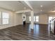 Spacious living room with hardwood floors, recessed lighting, and a black fireplace at 3354 Brunot St, New Hill, NC 27562