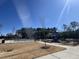 Community pool and playground with bright sunlight, surrounded by mature trees and landscaping at 3354 Brunot St, New Hill, NC 27562