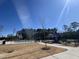 Community pool and playground with bright sunlight, surrounded by mature trees and landscaping at 3354 Brunot St, New Hill, NC 27562