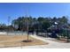 Community pool and playground, fenced in for privacy, surrounded by mature trees and landscaping at 3354 Brunot St, New Hill, NC 27562
