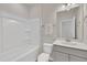 Clean bathroom with a white tub, toilet, and vanity with modern fixtures at 3381 Lovage Dr, Apex, NC 27502