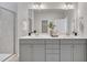 Bathroom featuring a double vanity, a large mirror, and sconce lighting at 3381 Lovage Dr, Apex, NC 27502