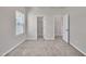 A neutral bedroom with carpeted floors, double door closet and a bright window at 3381 Lovage Dr, Apex, NC 27502