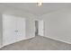 A neutral bedroom featuring carpeted floors and a double door closet at 3381 Lovage Dr, Apex, NC 27502