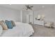 Bright bedroom boasts neutral tones, ceiling fan, and dresser with an oval mirror at 3381 Lovage Dr, Apex, NC 27502