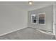 This is a light filled room with two adjacent bright windows and carpeted floors at 3381 Lovage Dr, Apex, NC 27502