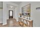 Inviting entryway with decorative console table, artwork, and a stylish front door at 3381 Lovage Dr, Apex, NC 27502