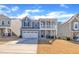 Two-story home with welcoming curb appeal, modern design, and a manicured lawn at 3381 Lovage Dr, Apex, NC 27502