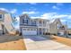 Attractive two-story home with a front-facing garage and quaint second story porch at 3381 Lovage Dr, Apex, NC 27502