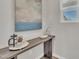 Bright hallway features a console table decorated with modern art and decor, and a large window at 3381 Lovage Dr, Apex, NC 27502