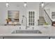 Kitchen island featuring stainless steel sink and faucet, white countertop, and pendant lighting at 3381 Lovage Dr, Apex, NC 27502