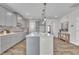 Open-concept kitchen featuring a large center island with bar seating and modern appliances at 3381 Lovage Dr, Apex, NC 27502