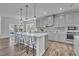 Modern kitchen boasts a large center island, stainless steel appliances, and stylish pendant lighting at 3381 Lovage Dr, Apex, NC 27502