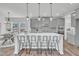 Well-designed kitchen featuring a central island, a view of the adjacent dining space, and modern finishes at 3381 Lovage Dr, Apex, NC 27502