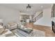Open-concept living space with fireplace, staircase, and modern kitchen view at 3381 Lovage Dr, Apex, NC 27502