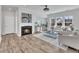 Bright living room with a fireplace, modern furnishings, and large windows at 3381 Lovage Dr, Apex, NC 27502