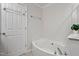 Bright bathroom featuring a soaking tub and neutral finishes at 3439 Archdale Dr, Raleigh, NC 27614