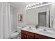 Bathroom featuring a double sink vanity, framed mirror, and shower with white shower curtain at 3439 Archdale Dr, Raleigh, NC 27614