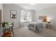 Bright bedroom with a workstation, a woven bed, and a large window at 3439 Archdale Dr, Raleigh, NC 27614