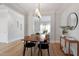 Bright dining room with hardwood floors, a table with seating, and an open view to the living room at 3439 Archdale Dr, Raleigh, NC 27614