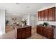 Open kitchen with dark wood cabinets flows into the living room, offering a seamless entertaining space at 3439 Archdale Dr, Raleigh, NC 27614
