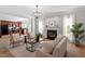 Inviting living room features a fireplace, natural light, and hardwood flooring at 3439 Archdale Dr, Raleigh, NC 27614