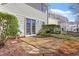 Back patio with stone pavers, landscaping, and view of the back of the home at 3439 Archdale Dr, Raleigh, NC 27614