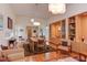 Spacious dining area with hardwood floors, large windows, and modern lighting fixtures at 3604 Pasture Rd, Hillsborough, NC 27278