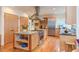 Kitchen island features a stovetop, oven, built-in shelving, and stainless steel appliances at 3604 Pasture Rd, Hillsborough, NC 27278