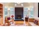 Bright living room features hardwood floors, fireplace, built-in shelves, and many windows at 3604 Pasture Rd, Hillsborough, NC 27278