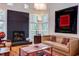 Bright living room features hardwood floors, fireplace, built-in shelves, and many windows at 3604 Pasture Rd, Hillsborough, NC 27278