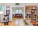 Open-concept living room with hardwood floors, a bookshelf, and a leather chair at 3604 Pasture Rd, Hillsborough, NC 27278