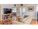 Open living room with a large leather couch and built in shelving at 3604 Pasture Rd, Hillsborough, NC 27278