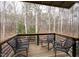 Inviting covered porch with comfortable seating and a view of the wooded surroundings at 3604 Pasture Rd, Hillsborough, NC 27278