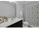 Bathroom featuring a single sink vanity with a shower and tub behind a patterned curtain at 3924 Volkswalk Pl, Raleigh, NC 27610