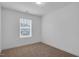 Small bedroom with neutral walls and carpet and a window with blinds at 3924 Volkswalk Pl, Raleigh, NC 27610