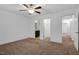 A bedroom with neutral walls and carpet, showing entryways to other rooms at 3924 Volkswalk Pl, Raleigh, NC 27610
