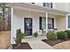 Inviting front porch with seating area and black trimmed front door at 3924 Volkswalk Pl, Raleigh, NC 27610
