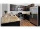 Stylish kitchen featuring granite countertops, stainless steel appliances, and dark cabinets at 3924 Volkswalk Pl, Raleigh, NC 27610